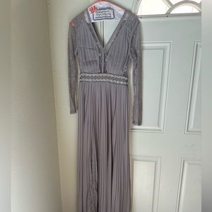 TNFC Pleated Maxi Dress with long sleeves, lace inserts, and embellished waist.